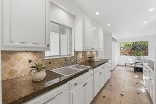 a living room with fireplace furniture and a large window