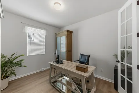 a view of a dining room with furniture and wooden floor