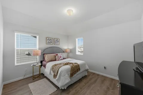 a bedroom with two beds and a window