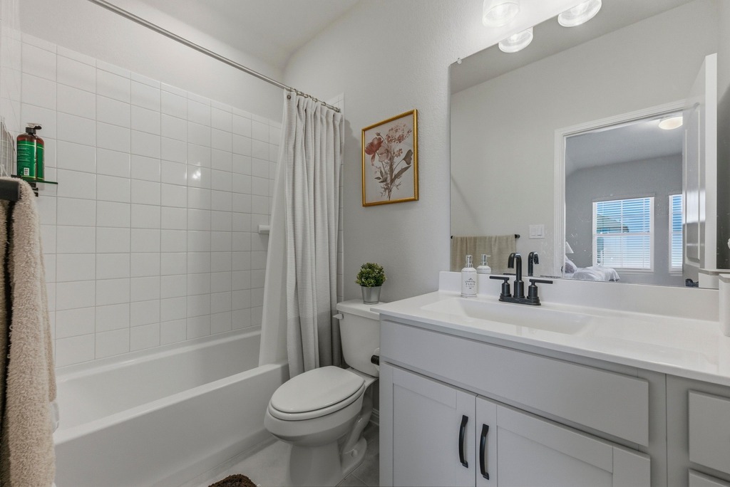 264 Denali Way Dripping Springs, TX 78620 - Photo 20 of 28 Bathroom with shower / bath combo with shower curtain and vanity
