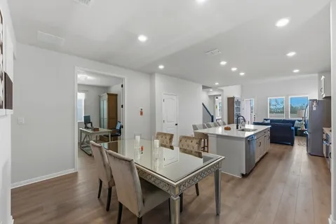a large kitchen with a table and chairs in it
