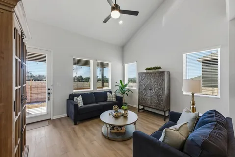 a kitchen with a dining table chairs refrigerator and microwave