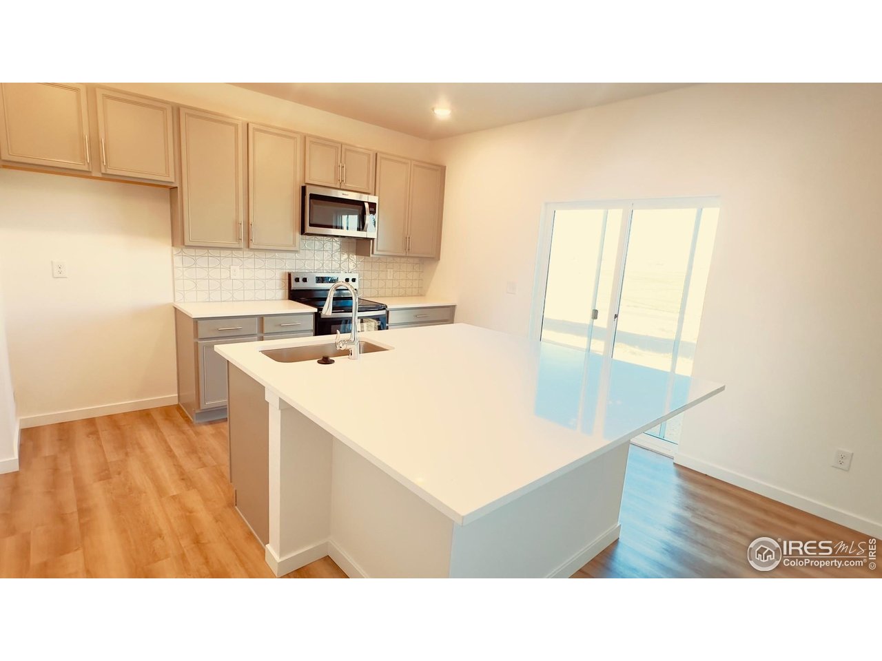 677 Muturu Road Johnstown, CO 80534 - Photo 2 of 11 a kitchen with stainless steel appliances a microwave a sink and cabinets