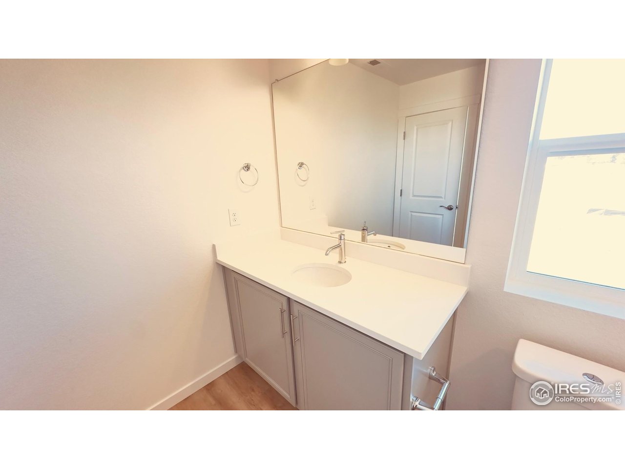677 Muturu Road Johnstown, CO 80534 - Photo 7 of 11 a bathroom with a sink vanity and a mirror