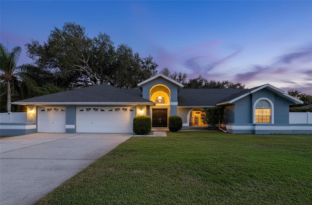 18812 Bascomb Lane Hudson, FL 34667 - Photo 1 of 57 a view of a house with a yard and large tree