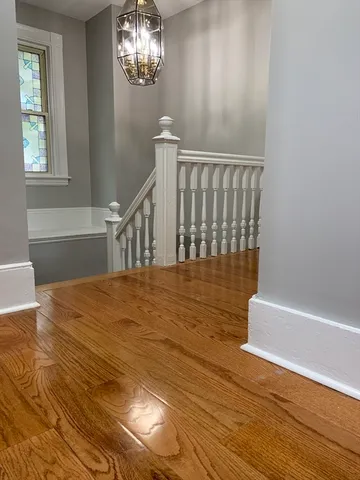 a view of entryway and hall with wooden floor