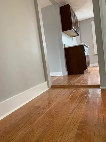 an empty room with wooden floor