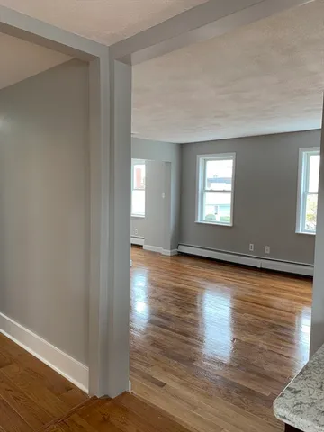 a view of a room with wooden floor and windows