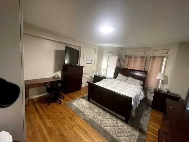 a bedroom with a bed and a dresser