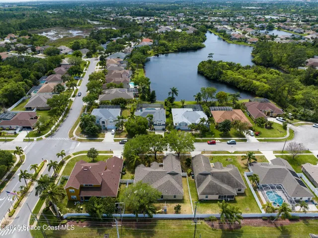 an aerial view of residential houses with outdoor space and swimming pool