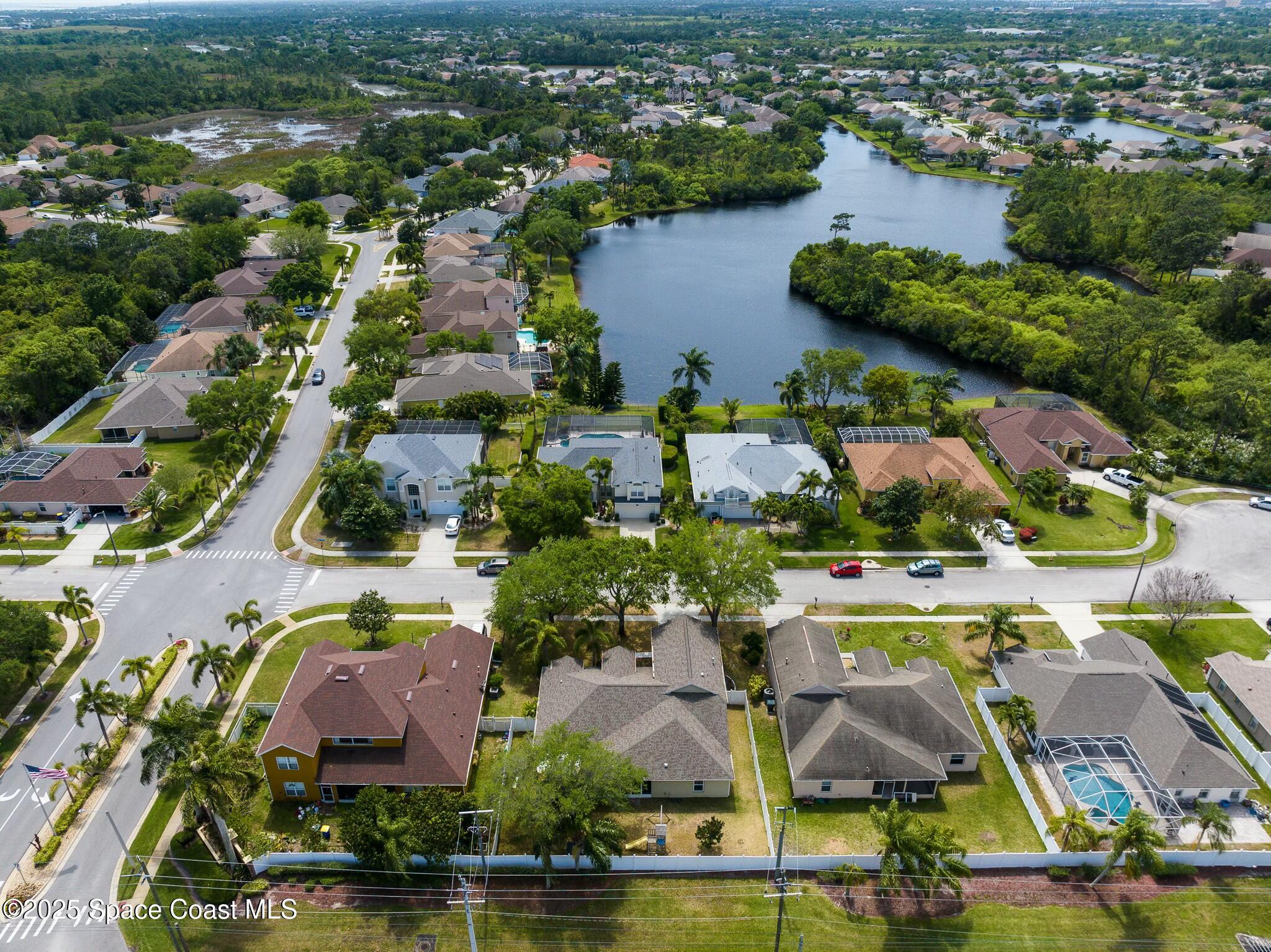 an aerial view of residential houses with outdoor space and swimming pool