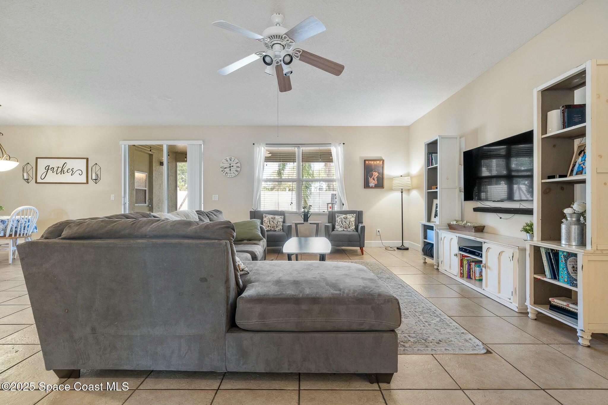 320 Pebble Hill Way Rockledge, FL 32955 - Photo 11 of 34 a living room with furniture and a flat screen tv