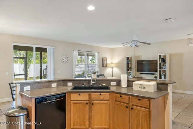a kitchen with a sink cabinets and window