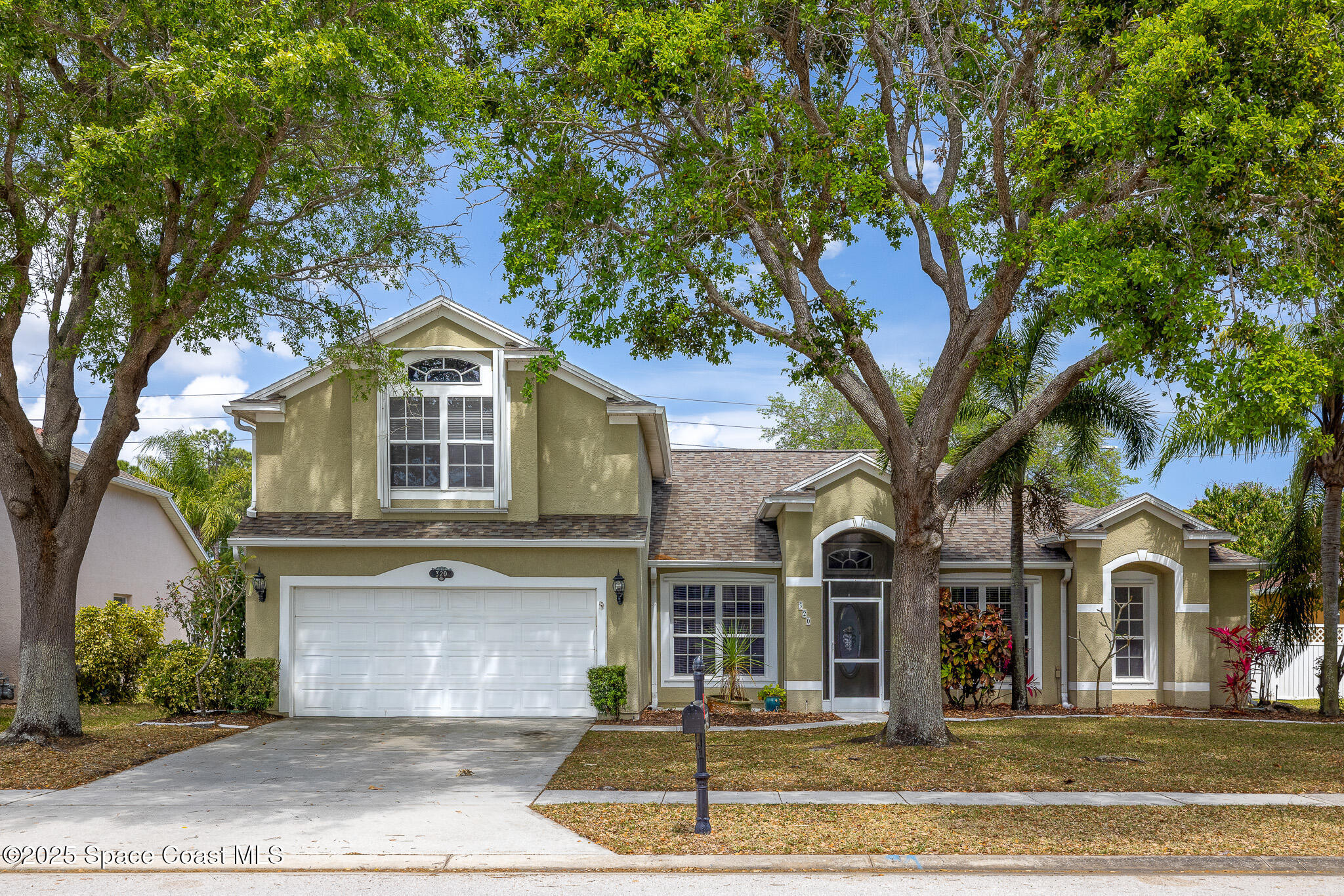 320 Pebble Hill Way Rockledge, FL 32955 - Photo 2 of 34 a front view of a house with a yard