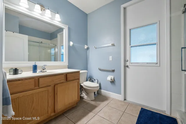 a spacious bathroom with a granite countertop sink toilet and shower