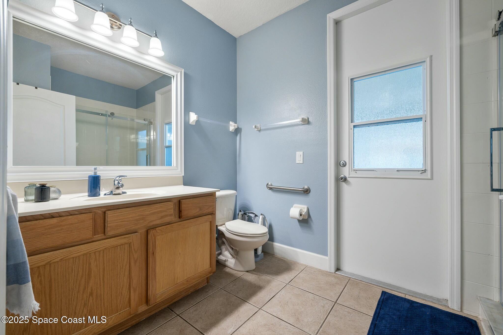 320 Pebble Hill Way Rockledge, FL 32955 - Photo 23 of 34 a spacious bathroom with a granite countertop sink toilet and shower