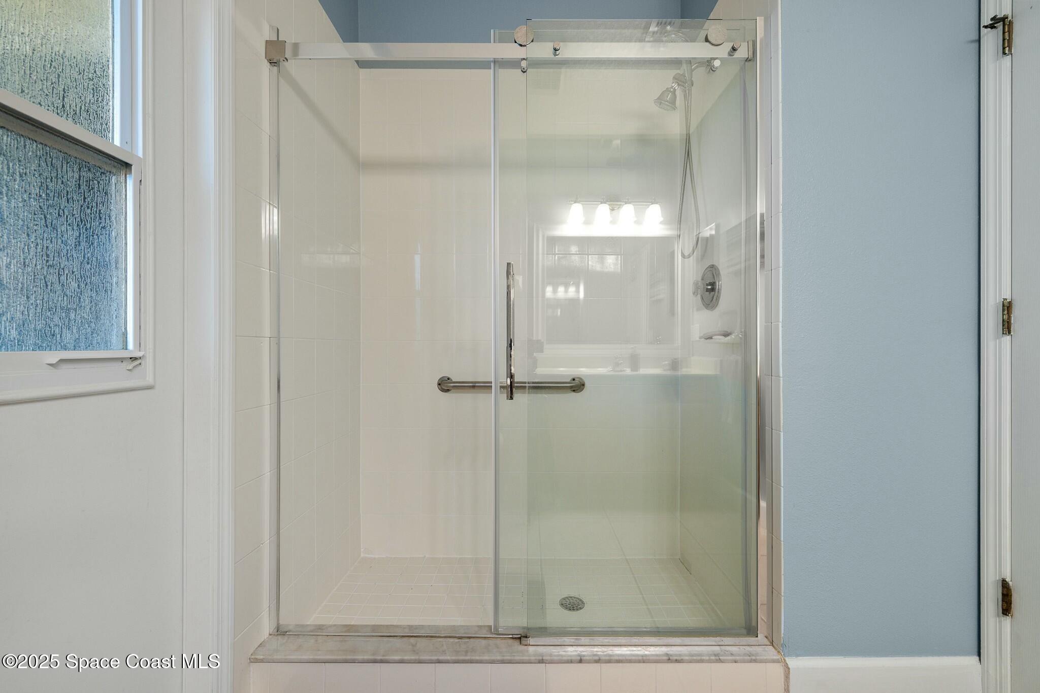 320 Pebble Hill Way Rockledge, FL 32955 - Photo 24 of 34 a bathroom with a glass shower door