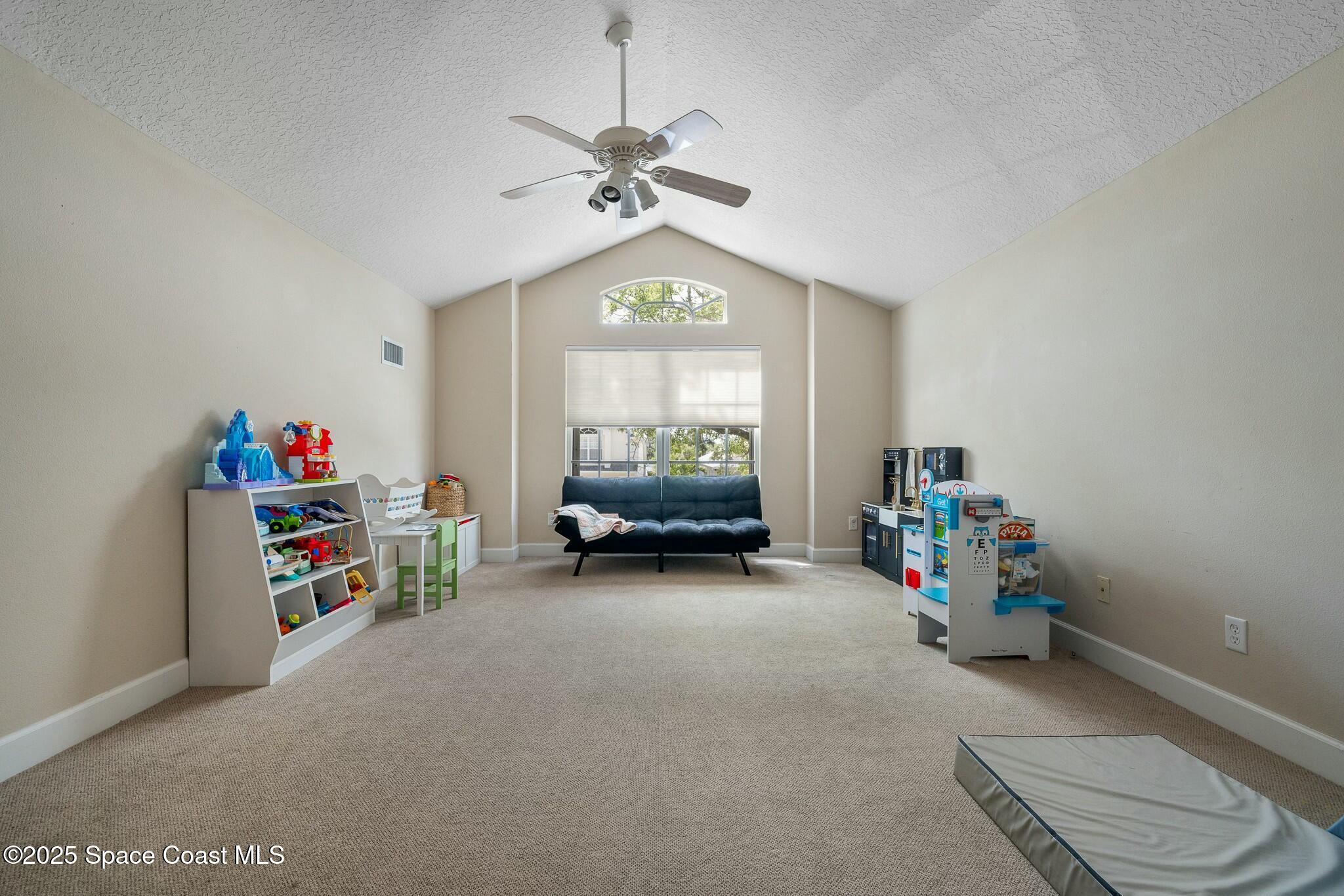 320 Pebble Hill Way Rockledge, FL 32955 - Photo 26 of 34 a view of a room with toys and a chandelier