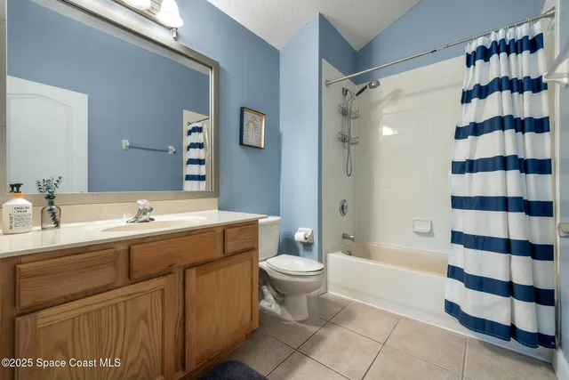 a bathroom with a double vanity sink toilet mirror and shower