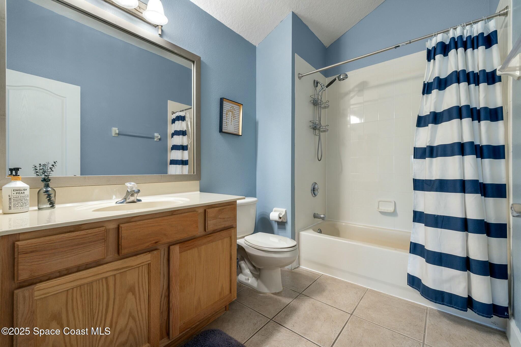 320 Pebble Hill Way Rockledge, FL 32955 - Photo 28 of 34 a bathroom with a double vanity sink toilet mirror and shower