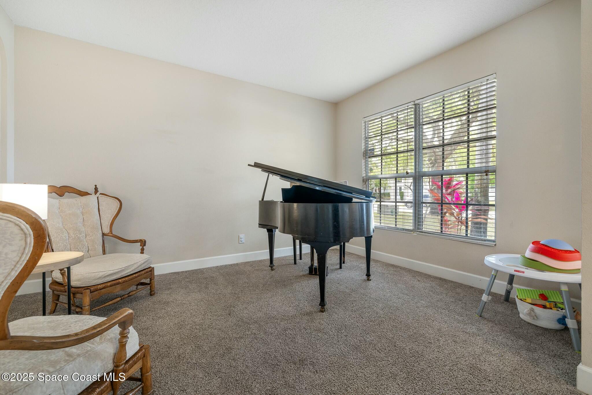 320 Pebble Hill Way Rockledge, FL 32955 - Photo 9 of 34 a living room with furniture and a window