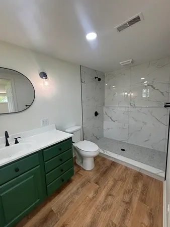 a bathroom with a toilet sink and shower