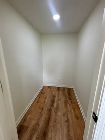 an empty room with wooden floor