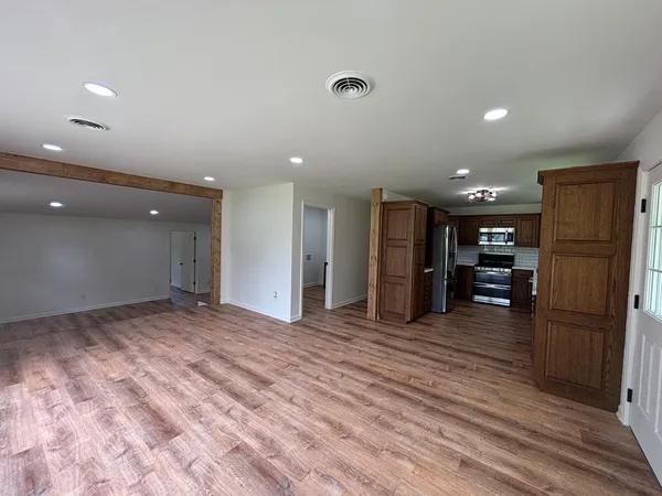 a view of a refrigerator in kitchen and wooden floor