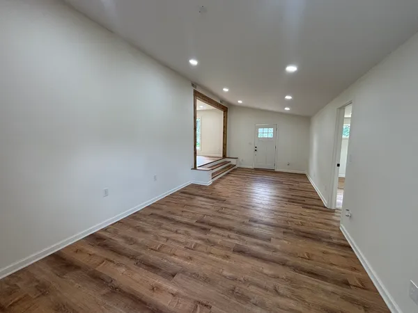 a view of room with wooden floor