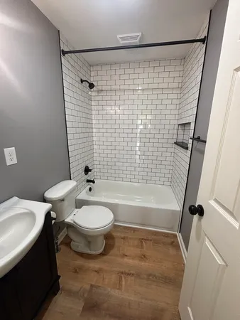 a bathroom with a sink toilet and shower