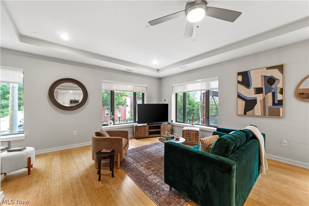 2044 Random Road, Unit 101 Cleveland, OH 44106 - Photo 8 of 44 Living room featuring light hardwood / wood-style floors, ceiling fan, and a raised ceiling
