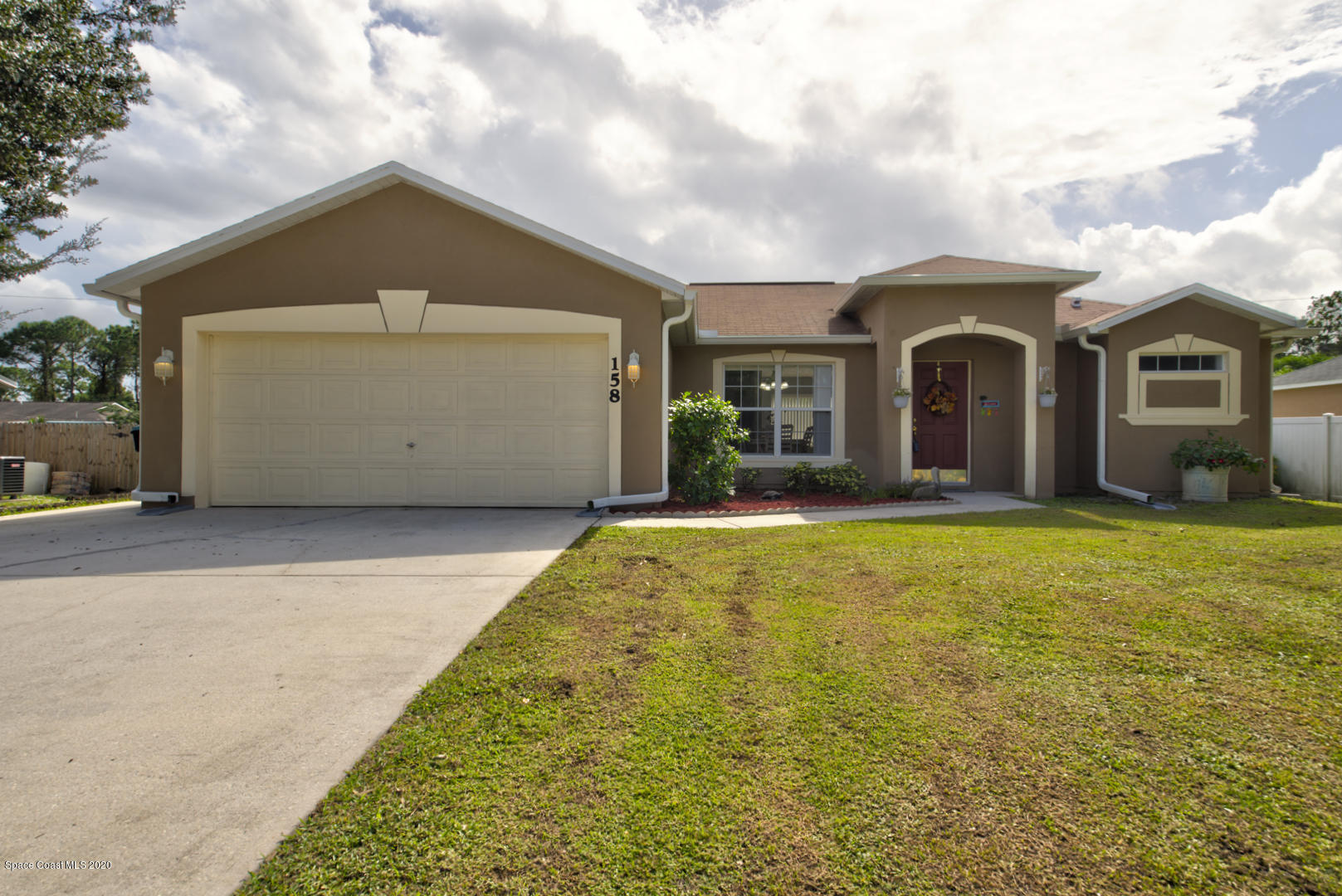 158 Tudor Road Southwest Palm Bay, FL 32908 - Photo 1 of 36 a front view of a house with a yard