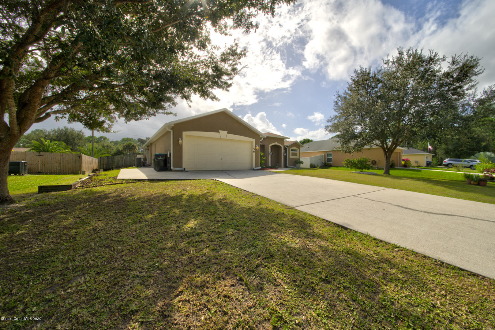 158 Tudor Road Southwest Palm Bay, FL 32908 - Photo 3 of 36 a view of a yard with a house and large trees