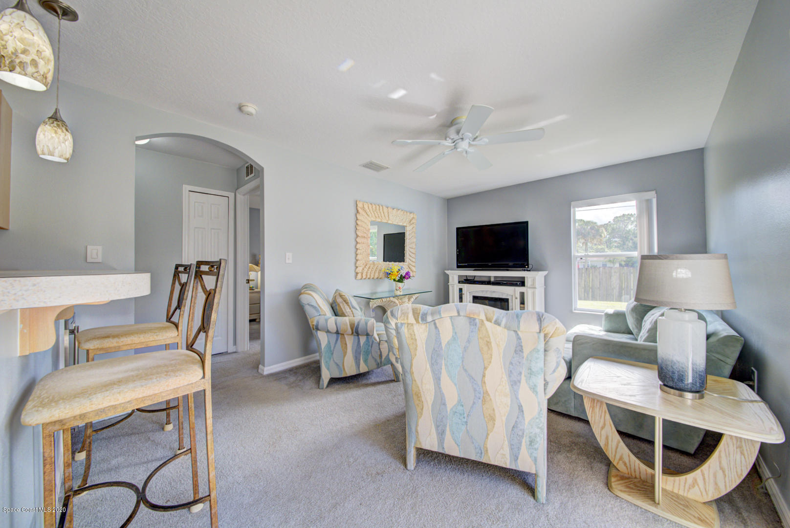 158 Tudor Road Southwest Palm Bay, FL 32908 - Photo 22 of 36 a living room with furniture and a flat screen tv