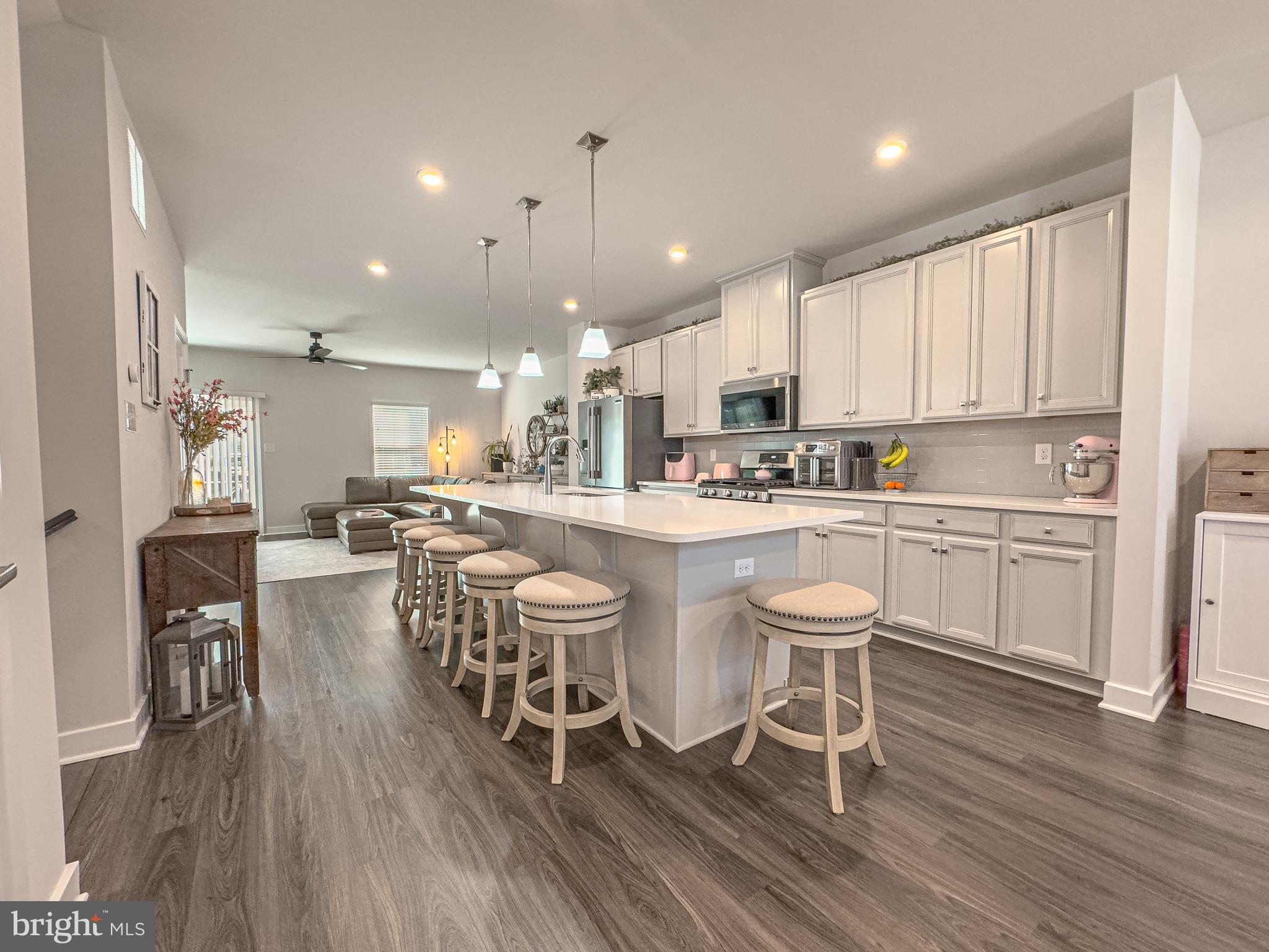 4 Flamingo Court Sewell, NJ 08080 - Photo 19 of 55 a kitchen with a dining table chairs wooden floor cabinets and stainless steel appliances