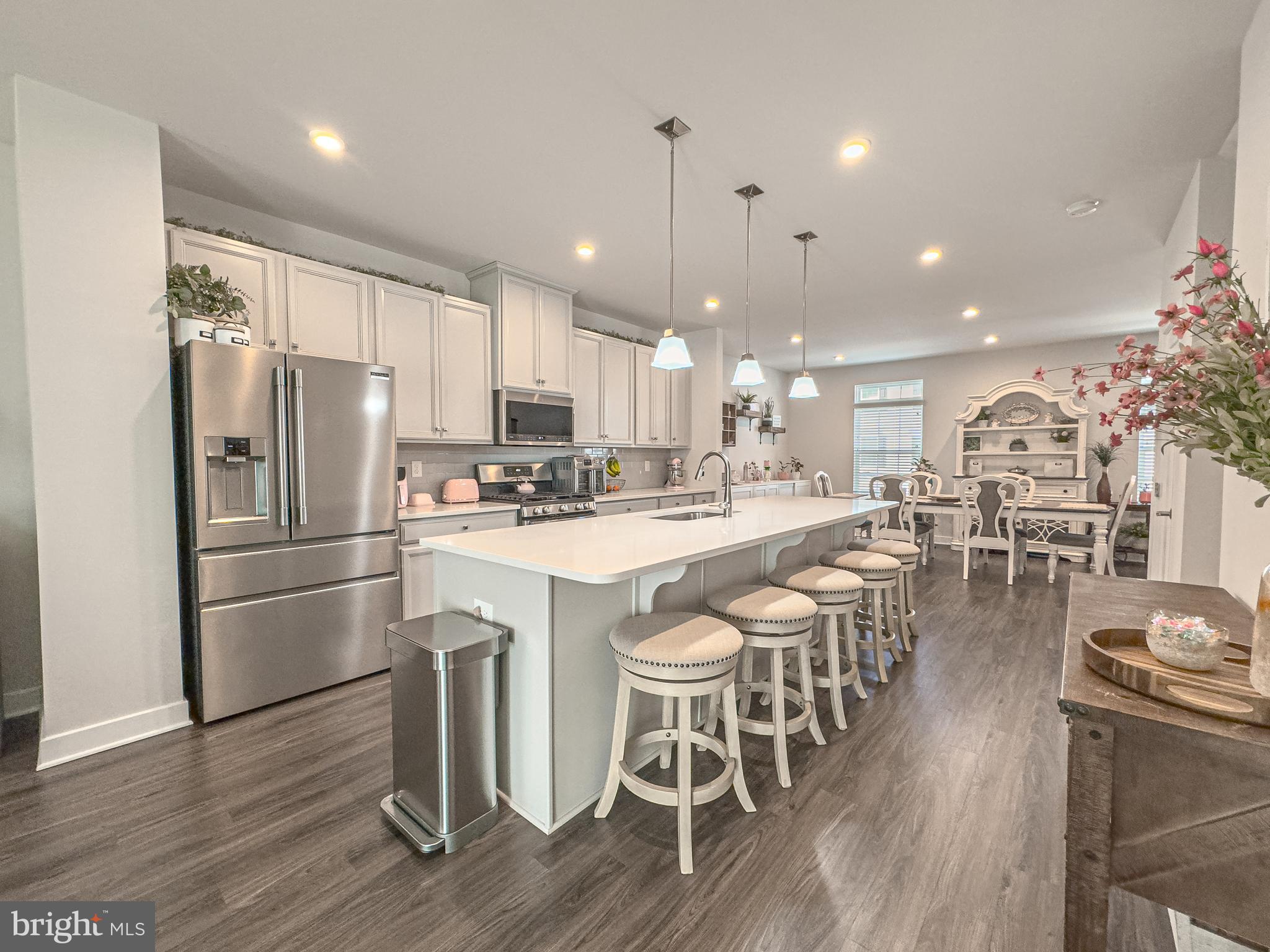 4 Flamingo Court Sewell, NJ 08080 - Photo 20 of 55 a kitchen with stainless steel appliances kitchen island granite countertop a refrigerator a stove a sink a dining table and chairs with wooden floor