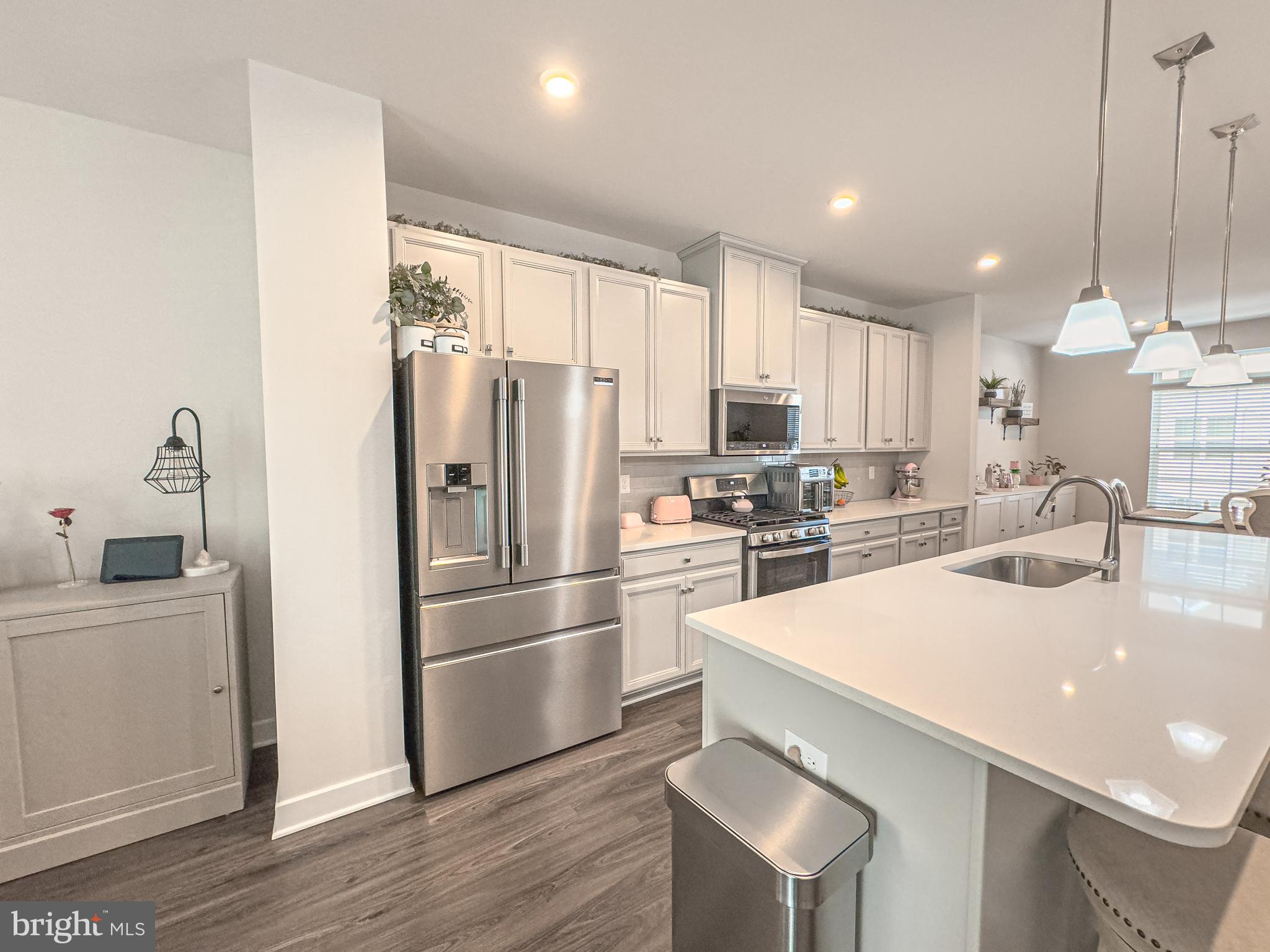 4 Flamingo Court Sewell, NJ 08080 - Photo 21 of 55 a kitchen with a refrigerator a sink and white cabinets