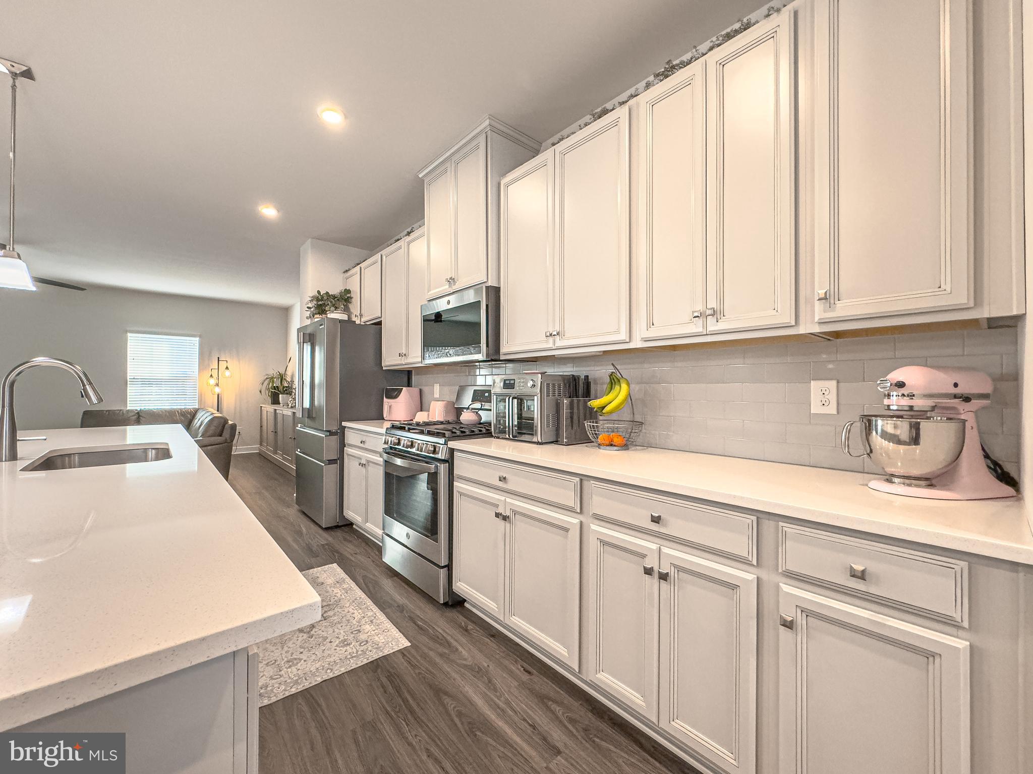 4 Flamingo Court Sewell, NJ 08080 - Photo 22 of 55 a kitchen with granite countertop white cabinets and white appliances