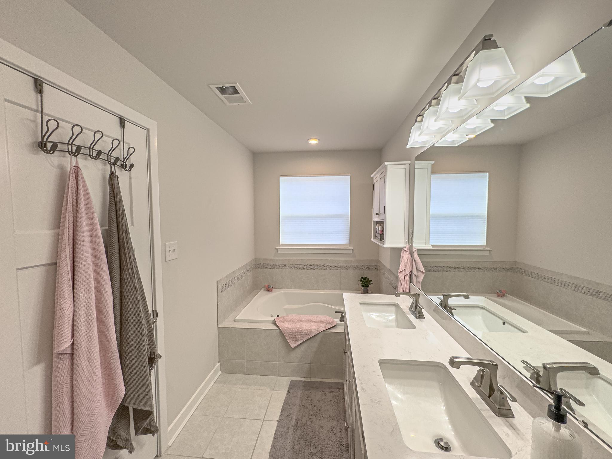 4 Flamingo Court Sewell, NJ 08080 - Photo 51 of 55 a bathroom with a tub sink and mirror