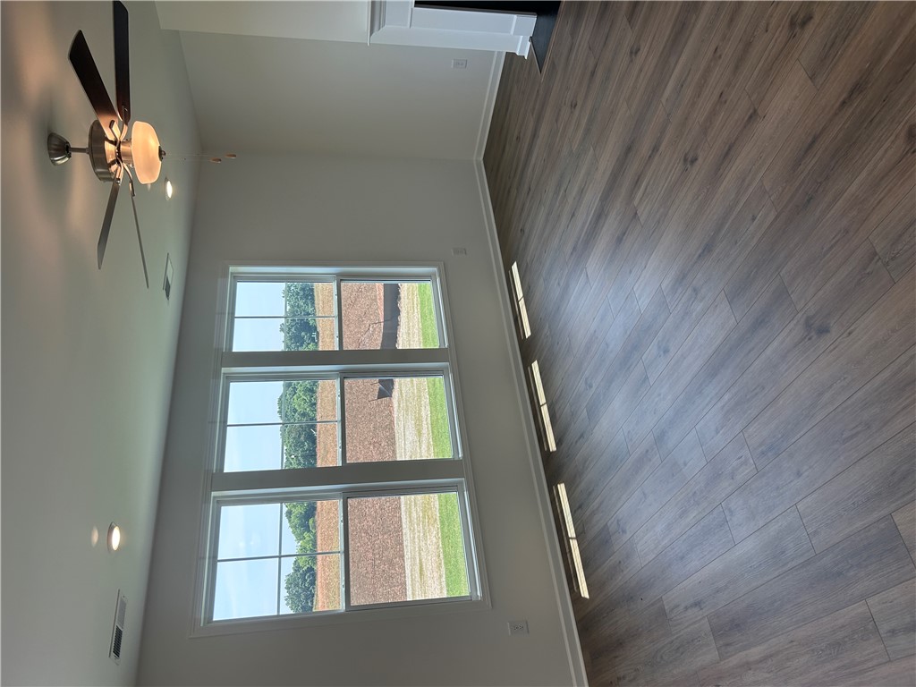 211 Bellflower Lane Anderson, SC 29625 - Photo 13 of 28 A spacious room features a ceiling fan, recessed lighting, and engineered wood flooring.