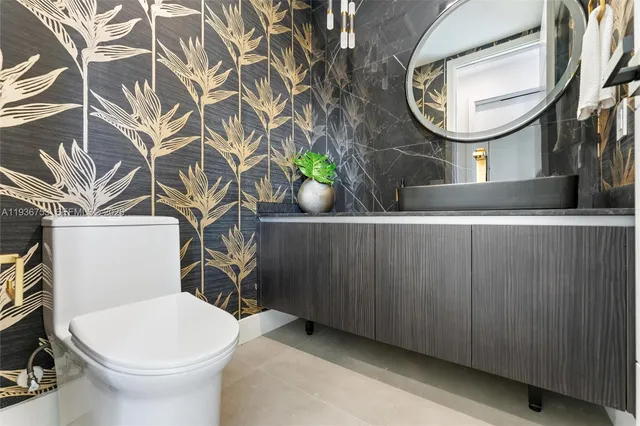 a bathroom with a toilet a sink and a mirror