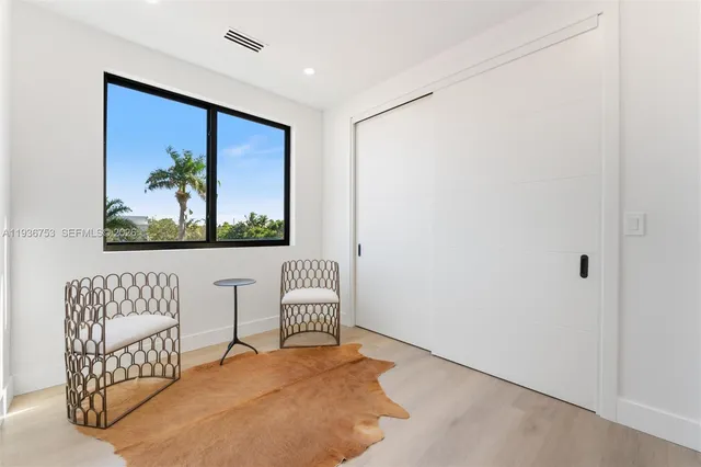 a view of a livingroom with furniture and cabinet with rug