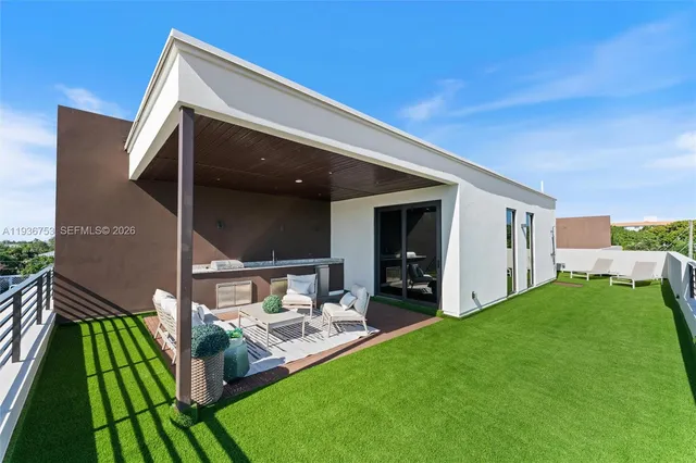 a front view of house with yard and outdoor seating