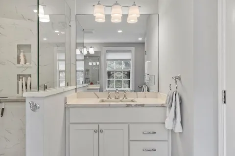 a bathroom with a sink vanity and a mirror