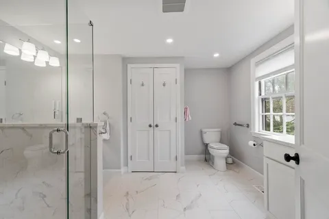 a bathroom with a shower and a toilet
