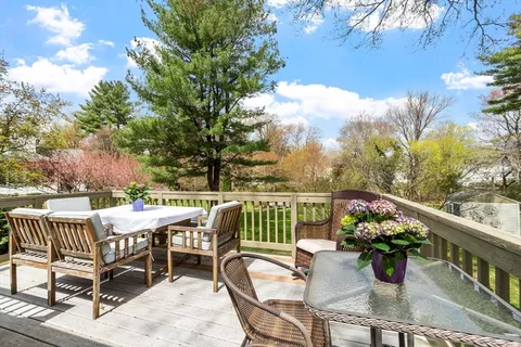 a view of a house with backyard and a sitting area