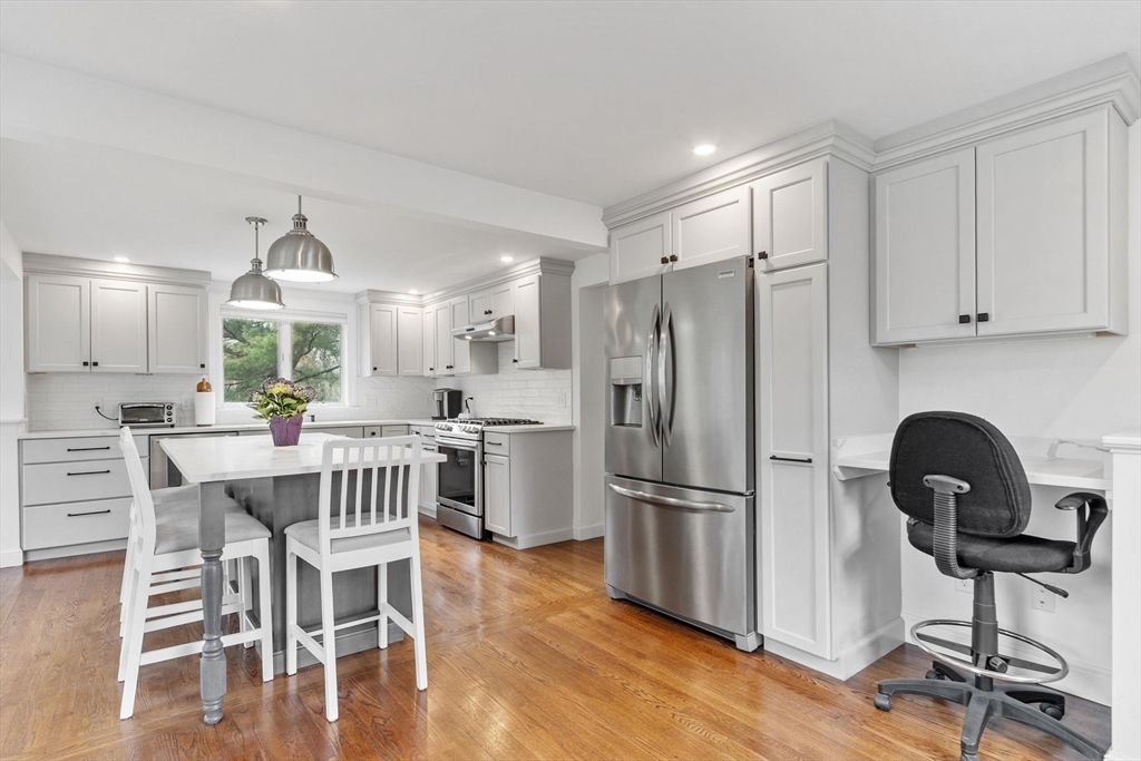 122 Southfield Road Concord, MA 01742 - Photo 3 of 28 a kitchen with stainless steel appliances granite countertop a dining table chairs refrigerator and sink