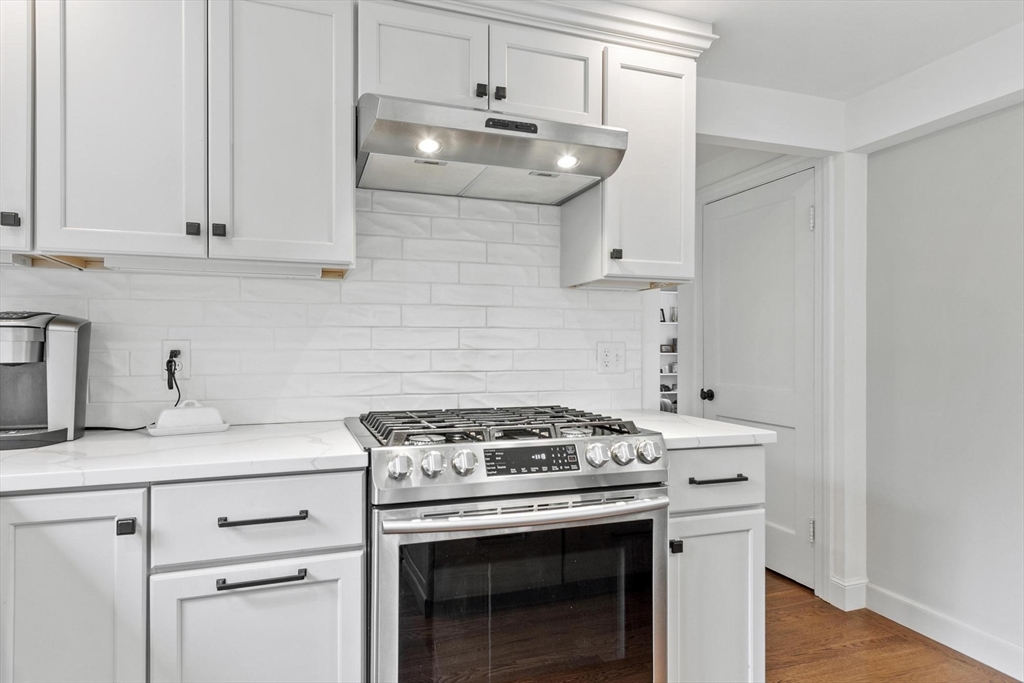 122 Southfield Road Concord, MA 01742 - Photo 5 of 28 a kitchen with granite countertop a sink stove and cabinets