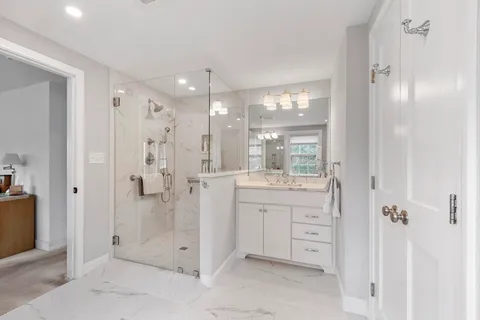 a bathroom with a shower sink and mirror