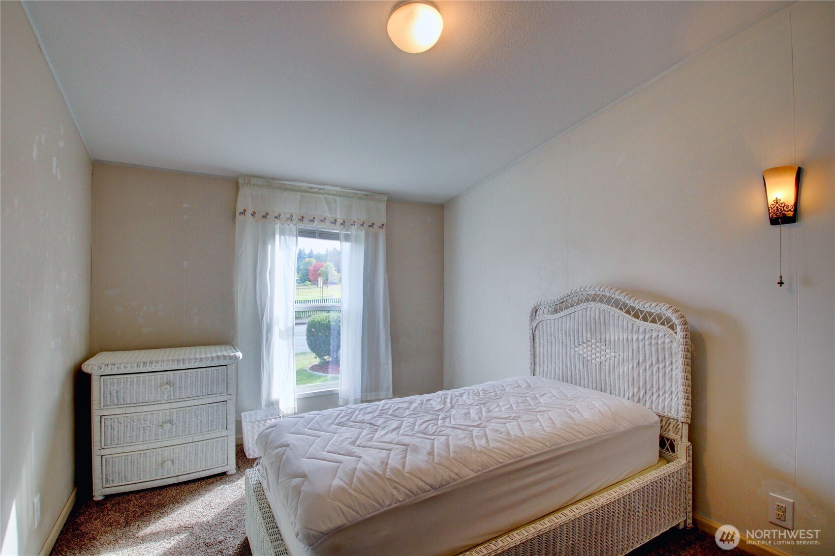 2901 Schuller Place Mount Vernon, WA 98273 - Photo 16 of 40 a bedroom with a bed and a lamp next to a window